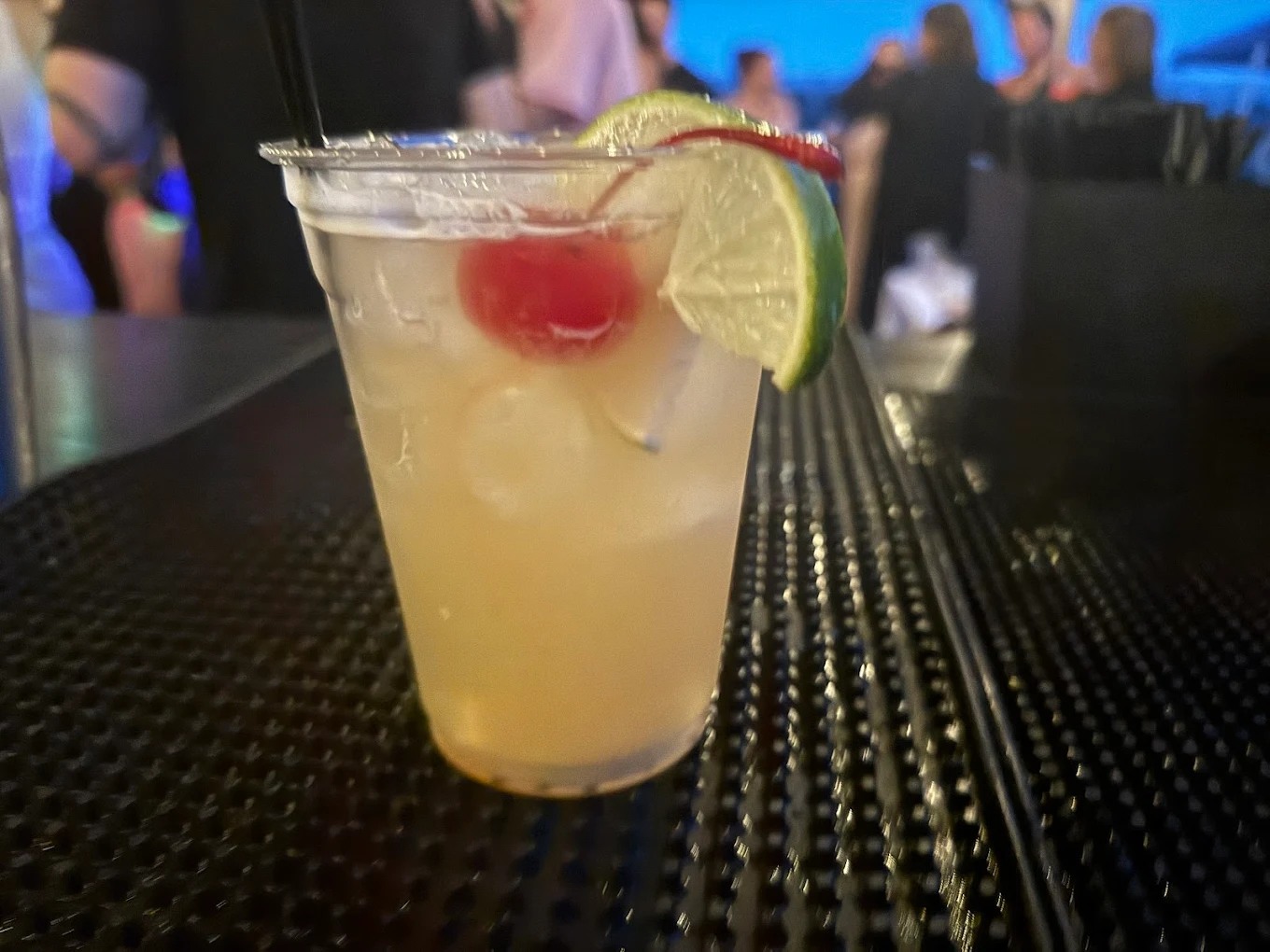 Signature cocktail with cherry and lime garnish at event